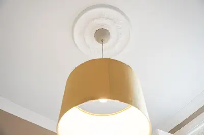 a light hanging from a ceiling with a fan at GuestReady - Charming Gaia apartment in Vila Nova de Gaia