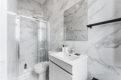 a white bathroom with a toilet and a sink at GuestReady - Charming Gaia apartment in Vila Nova de Gaia