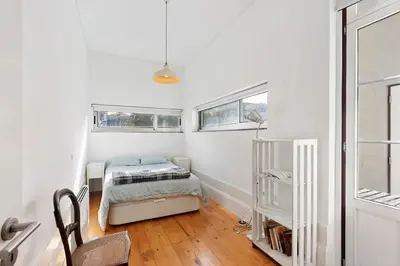 a small bedroom with a bed and a window at Breiner House Porto in Porto