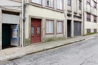 a red door on a building on a city street at Breiner House Porto in Porto
