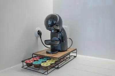 a coffee maker sitting on a stand with cupcakes at Modern Flat with balcony on Rua das Flores - 2nd in Porto