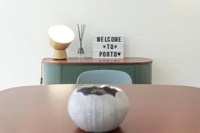 a white vase sitting on top of a table at Modern Flat with balcony on Rua das Flores - 3rd in Porto
