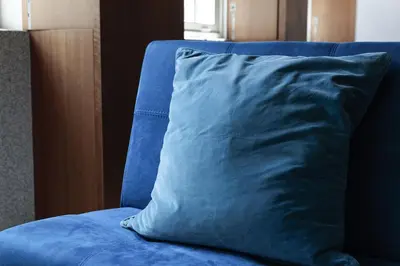a blue pillow sitting on top of a blue couch at Modern Flat on Rua das Flores - 4th Floor in Porto