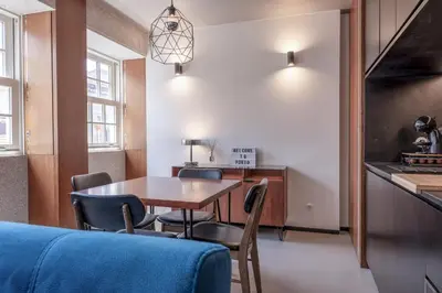 a kitchen and dining room with a table and chairs at Modern Flat on Rua das Flores - 4th Floor in Porto