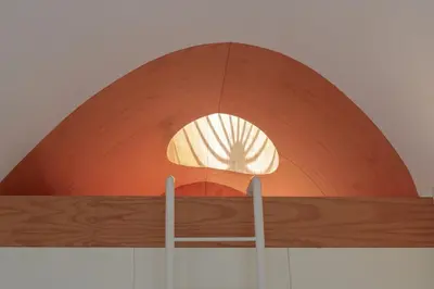 a light hanging from the ceiling of a building at Modern Flat with balcony on Rua das Flores - 5th in Porto