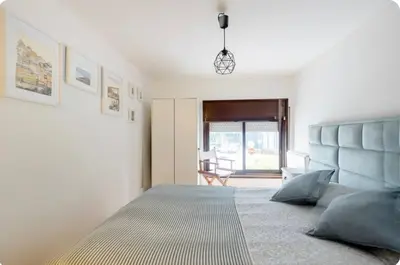 a bedroom with a large bed with a blue headboard at Full 3-Room Apt Downtown Casa do Livro Boavista in Porto