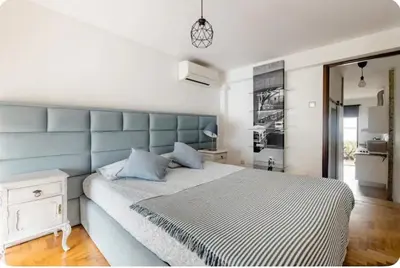 a bedroom with a large bed with a blue headboard at Full 3-Room Apt Downtown Casa do Livro Boavista in Porto