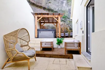 a porch with a chair and a gazebo at NEW! House with Hot Tub by Douro River & Iconic Bridge in Vila Nova de Gaia