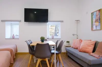 a living room with a table and a couch at NEW! House with Hot Tub by Douro River & Iconic Bridge in Vila Nova de Gaia
