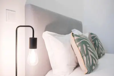 a bed with two pillows and a lamp on it at GuestReady - Douro D'or Apartments in Vila Nova de Gaia