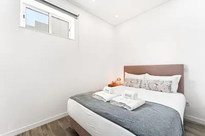 a bedroom with a bed with two towels on it at GuestReady - Douro D'or Apartments in Vila Nova de Gaia