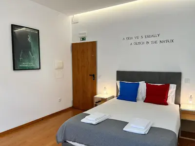 a bathroom with a toilet and a sink and a shower at Clérigos Cinema Guesthouse in Porto