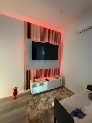 a room with a tv on a wall with a bed at Casinha de Campanhã in Porto