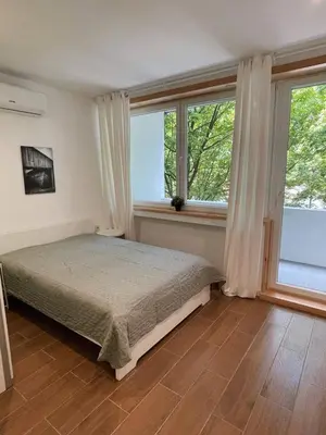 a bedroom with a bed and two windows at Bandeira Place in Porto
