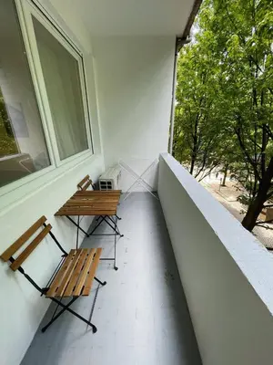 two benches sitting on a balcony with a window at Bandeira Place in Porto