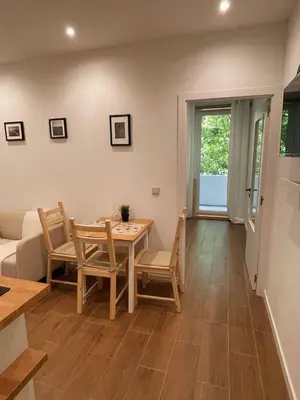 a living room with a table and chairs and a couch at Bandeira Place in Porto