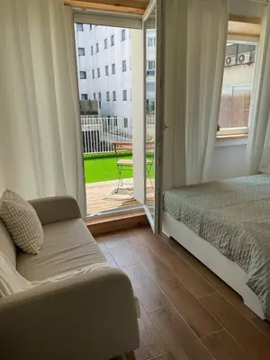 a bedroom with a bed and a sliding glass door at Bandeira Place in Porto
