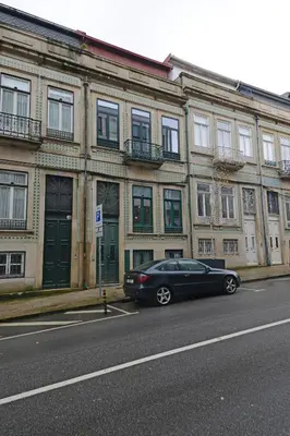 a black car parked in front of a building at Bright Cedofeita Flat with Balcony in Porto