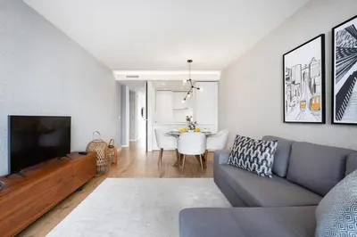 a dining room and living room with a table and chairs at Avenue 104 @ Porto Renovato, Bonfim in Porto