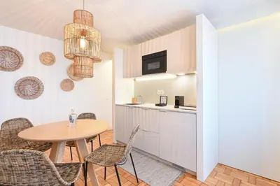 a kitchen and dining room with a table and chairs at Sleep in Office by ON Apartments in Porto
