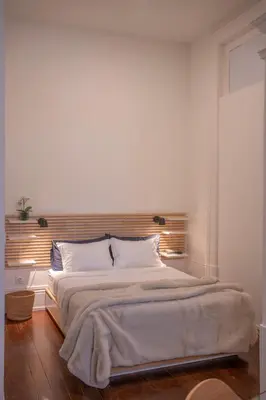 a white bedroom with a large bed with white pillows at Historic Porto Stay, Classic Details, City Life in Porto