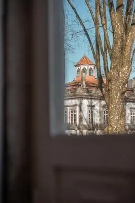 an old building with a tree in front of it at Historic Porto Stay, Classic Details, City Life in Porto