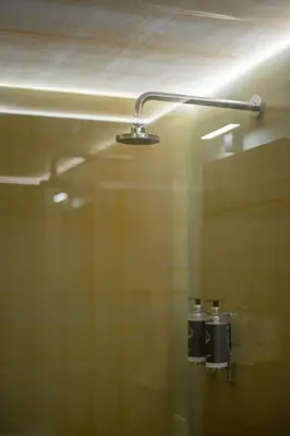 a bathroom with a shower with a light on the ceiling at Hut E, Cabana in Town in Porto