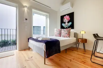 a bedroom with a bed and a large window at Luxury Style 5 with AC Downtown Porto near Metro in Porto