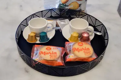 a plate with two cups and snacks on a table at Luxury Style 5 with AC Downtown Porto near Metro in Porto