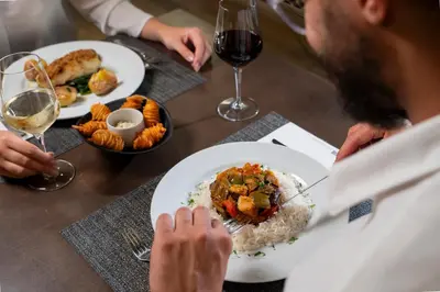 a man sitting at a table with a plate of food at HF Ala Sul in Porto