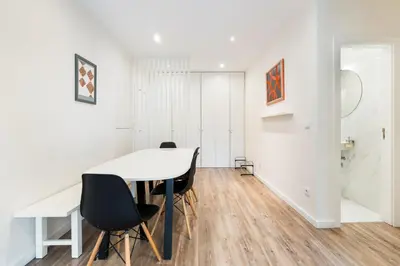 a dining room with a white table and chairs at GuestReady - Cosy family home in the Bonfim area in Porto