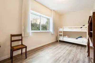 a bedroom with two bunk beds and a window at GuestReady - Cosy family home in the Bonfim area in Porto