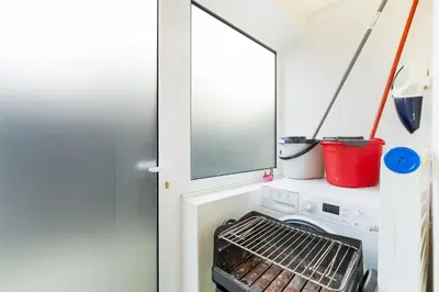 a small kitchen with a stove and a window at GuestReady - Cosy family home in the Bonfim area in Porto