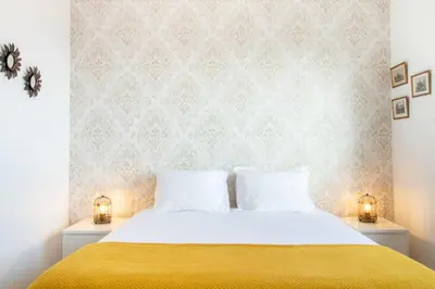 a bedroom with a bed with a yellow blanket at Violet House by LovelyStay in Vila Nova de Gaia