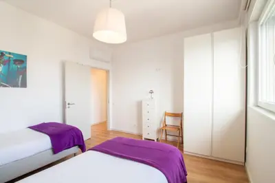 a bedroom with two beds and a window at Violet House by LovelyStay in Vila Nova de Gaia