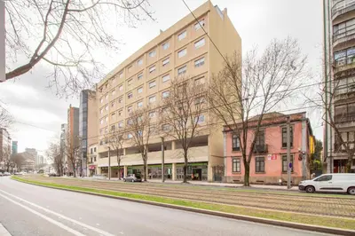 an empty city street with a large building at Violet House by LovelyStay in Vila Nova de Gaia