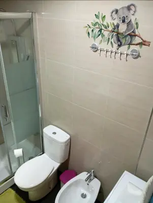 a bathroom with a toilet and a glass shower at Glimpses of Australia in Porto