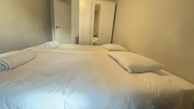 a white bed with two pillows on top of it at Classic Freitas in Porto