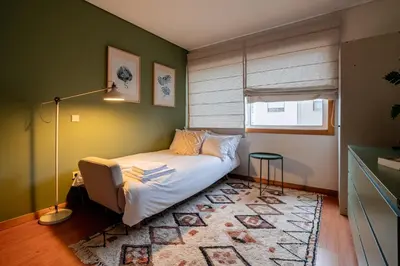 a bedroom with a bed in a room with green walls at Green Studio near Metro, Cedofeita, Porto in Porto