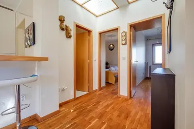 a hallway with white walls and wood floors and a ceiling at 2 Bdr Guadiana House Garden Metro Station 2min in Porto