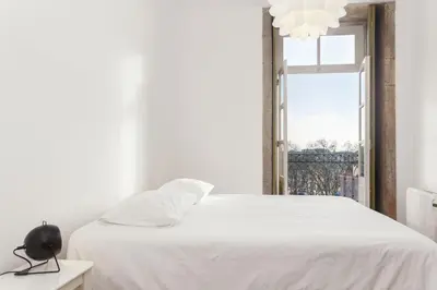 a bedroom with a white bed and a window at Belly Angel - Porto Historic Center in Porto