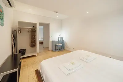a white room with a bed with towels on it at Porto Window House by Vacationy in Bandeira