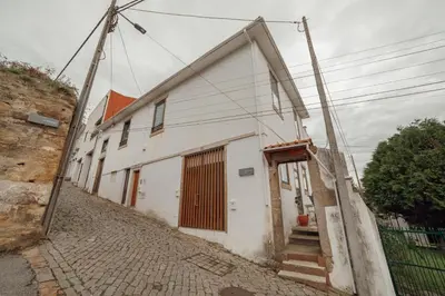 a white building with a door on a street at Porto Window House by Vacationy in Bandeira