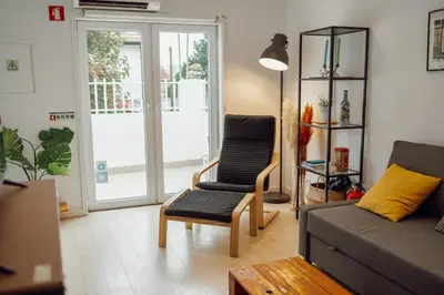 a living room with a couch and a chair at Porto Window House by Vacationy in Bandeira