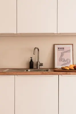 a kitchen with white cabinets and a sink at Apartment Nunno in Porto