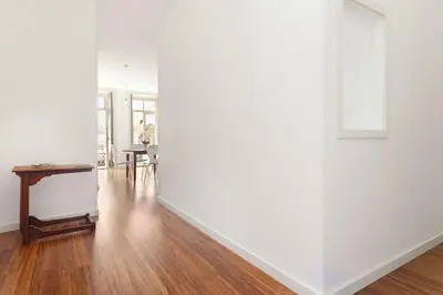 an empty room with a table and a white wall at Egg Nuts Apartment in Porto