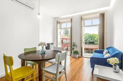 a living room with a table and chairs at Egg Nuts Apartment in Porto