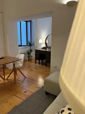 a living room with a table and a desk at Quiet, bright apt near Bolhão in Porto