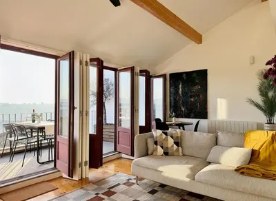 a living room with a couch and a balcony at Sol Do Porto - 2 bed Penthouse Luis Bridge view in Porto