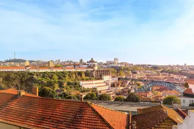 a view of a city with buildings and a bridge at Sol Do Porto - 2 bed Penthouse Luis Bridge view in Porto